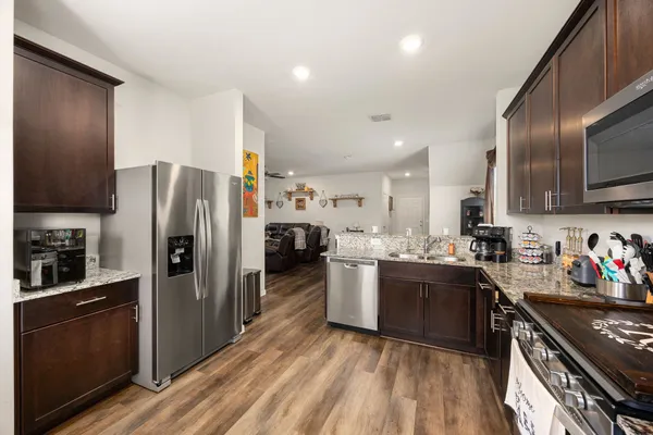 a kitchen with refrigerator and cabinets