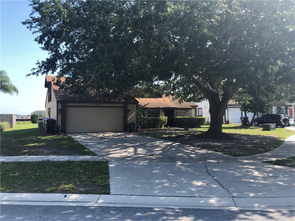 2103 Winding Ridge Avenue North Kissimmee, FL 34741 - Photo 1 of 1 a view of a house with a yard and large tree