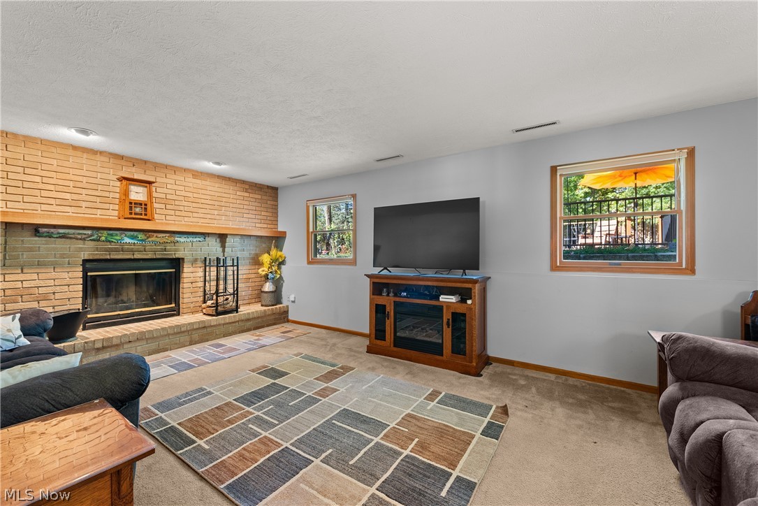 75 Houghton Road Northfield, OH 44067 - Photo 10 of 48 Brick fireplace with a wood mantel