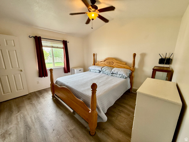 1353 360 West Payson, UT 84651 - Photo 8 of 16 Bedroom with vaulted ceiling, wood-finish flooring, and a ceiling fan with integrated lighting