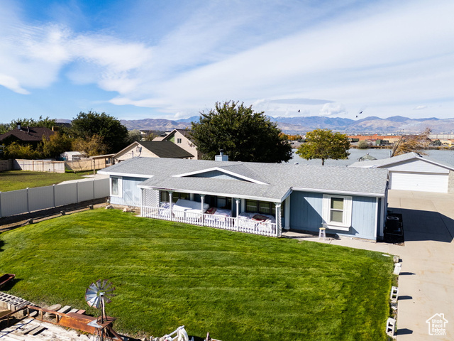 12958 South 300 East Draper, UT 84020 - Photo 30 of 38 View of front of house featuring a shingled roof, driveway, a garage, and a mountain view