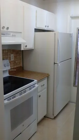 a white refrigerator freezer sitting inside of a kitchen