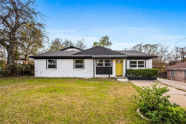a front view of a house with a yard garage and outdoor seating