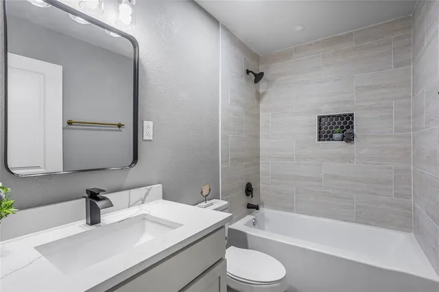 a bathroom with a sink a toilet and a bathtub