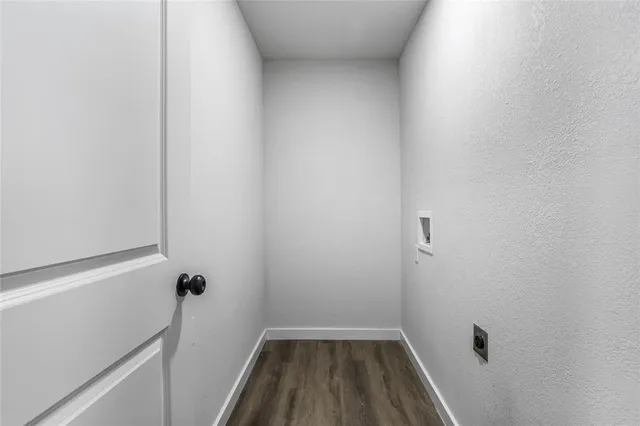 a view of a room with wooden floor