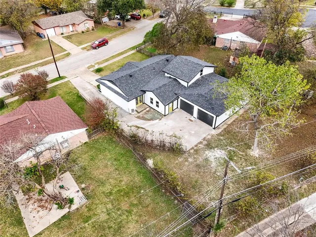 an aerial view of residential houses with outdoor space