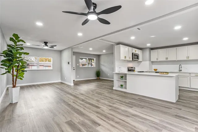a view of kitchen with sink and wooden floor