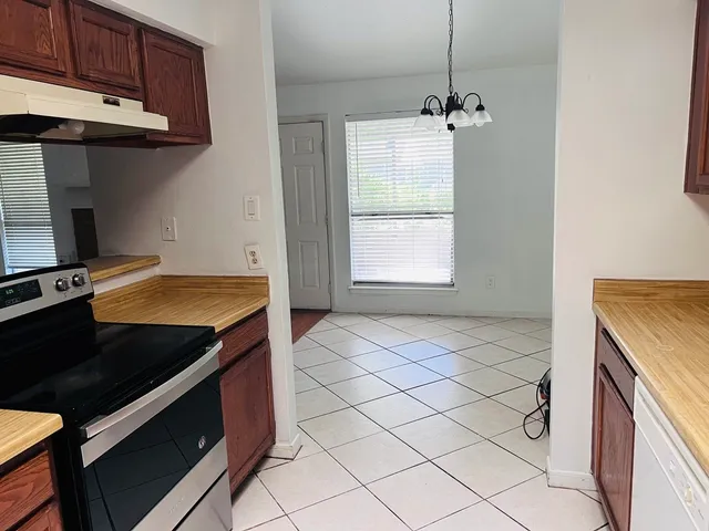 a kitchen with a sink refrigerator and cabinets