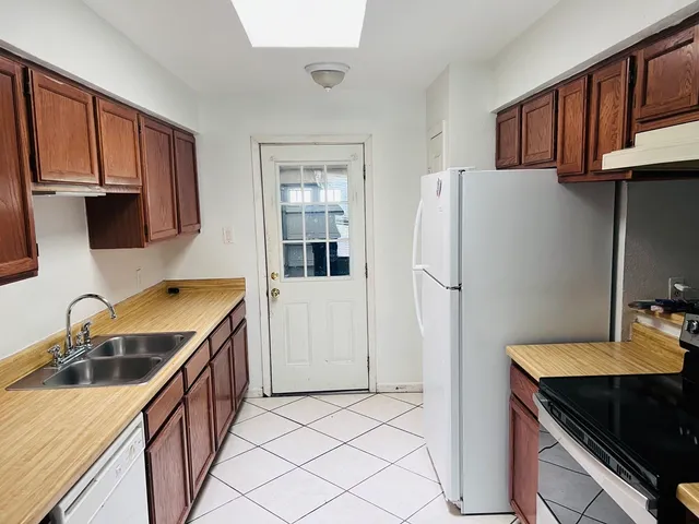 a close view of walk in closet with wooden floor