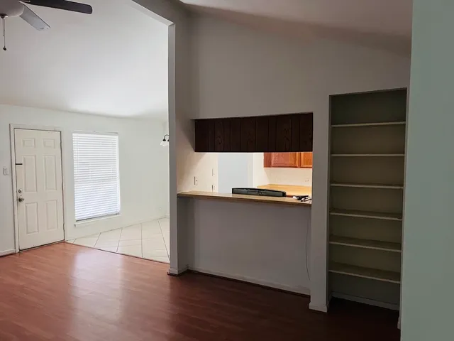 an empty room with windows and a fireplace