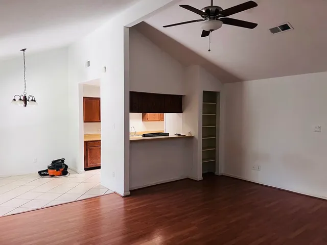 a living room with hard wood floors and white walls
