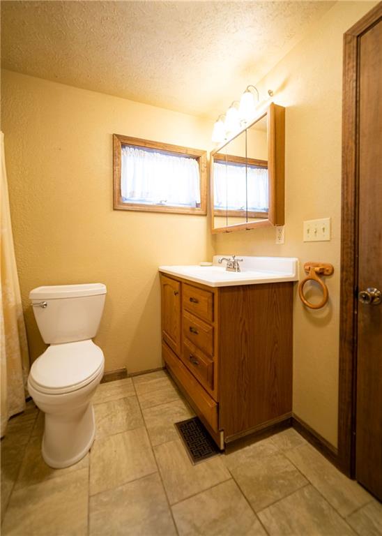 290 Schlemmer Road Rural Valley, PA 16249 - Photo 10 of 25 a bathroom with a granite countertop toilet and a sink