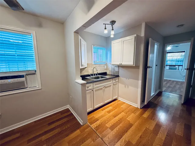 a kitchen with a refrigerator and a stove top oven