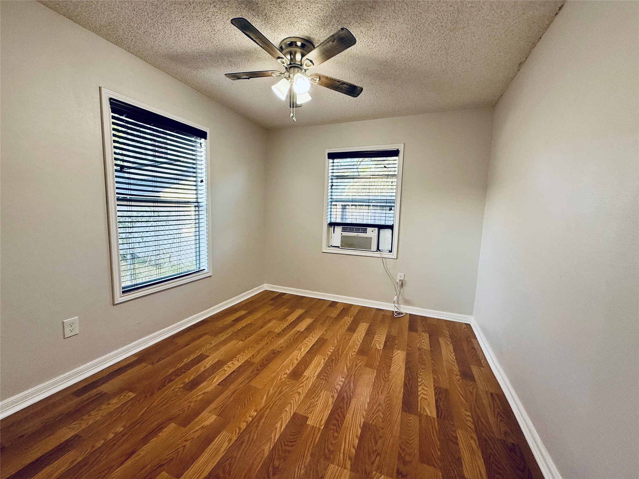 3921 Woodleigh Street, Unit 3 Houston, TX 77023 - Photo 3 of 6 a view of an empty room with a window and a chandelier fan