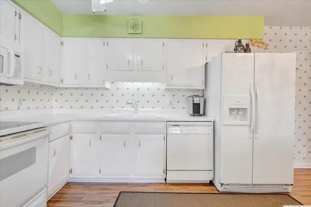 a white refrigerator freezer sitting inside of a kitchen