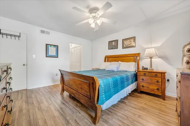 a bedroom with a bed and wooden floor