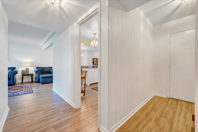 a view of a hallway view with wooden floor and staircase