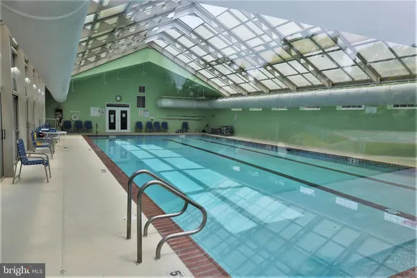 a swimming pool with a outdoor seating and yard