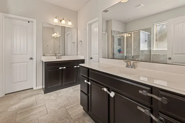 a spacious bathroom with a sink and a mirror