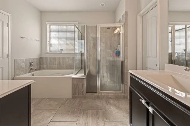 a bathroom with a bathtub and a sink