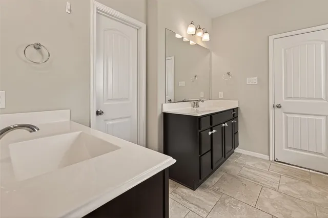a bathroom with a sink vanity and a mirror