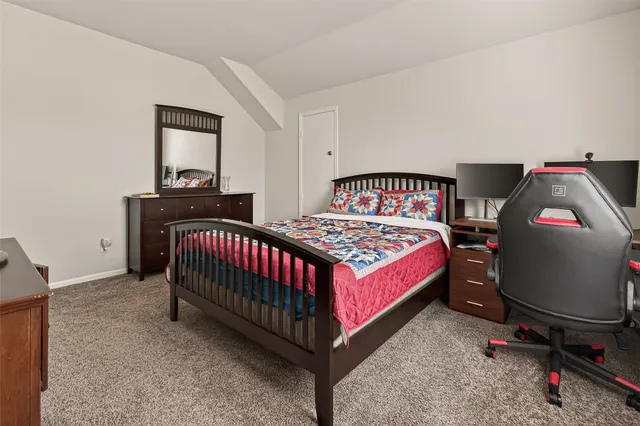 a bedroom with a bed and dresser