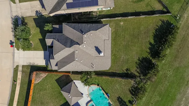 an aerial view of a house with a yard
