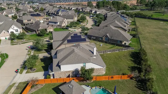 an aerial view of residential houses with outdoor space