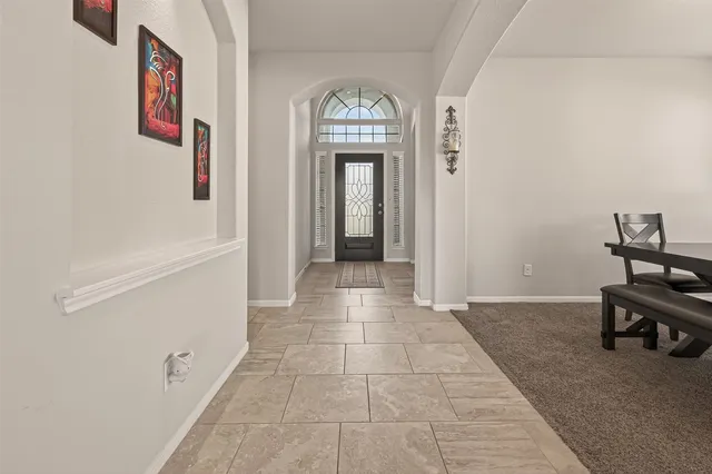 a view of a hallway with entryway door