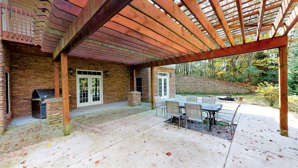 1153 Reynolds Bridge Road Benton, TN 37307 - Photo 54 of 70 a view of a patio with a table and chairs under an umbrella