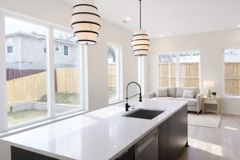 a kitchen with a sink a counter and appliances