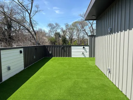 a view of a house with pool and trees in the background