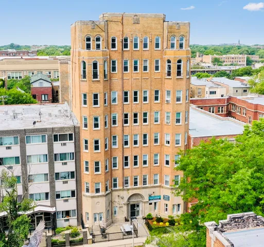 a front view of a building with a garden