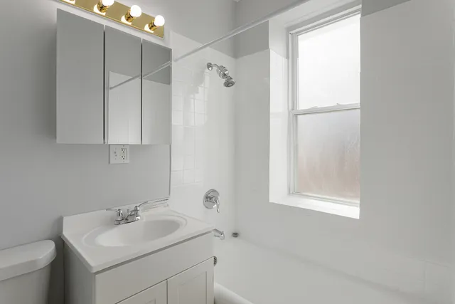 a bathroom with a sink toilet and shower