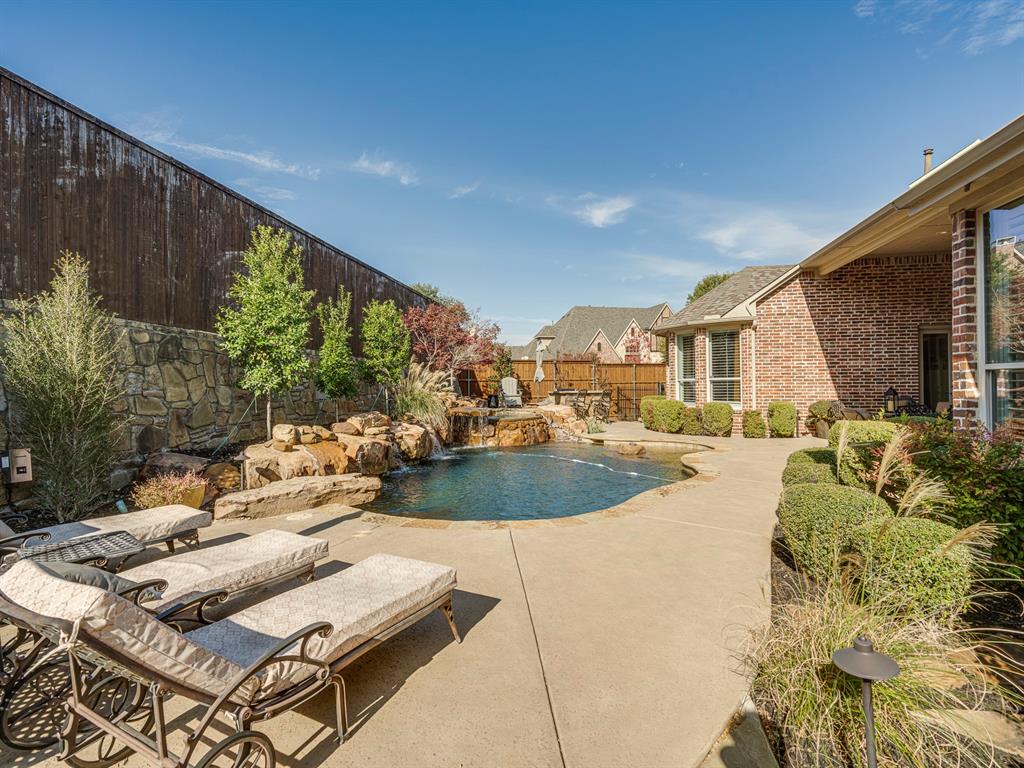 a view of swimming pool with outdoor seating and plants