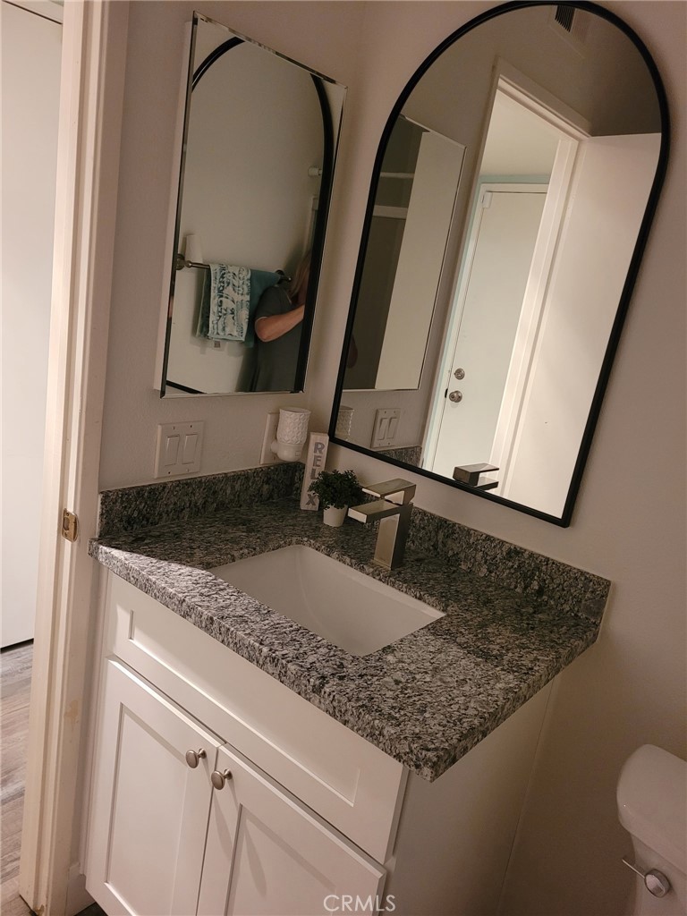 46 Celosia Rancho Santa Margarita, CA 92688 - Photo 15 of 39 a bathroom with a granite countertop sink and a mirror