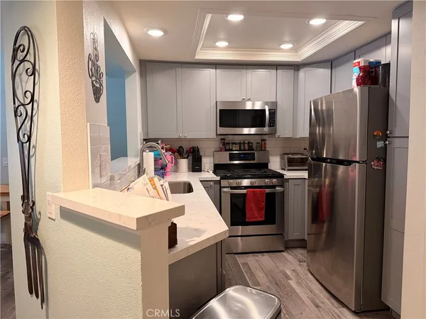 a kitchen with a refrigerator and a sink