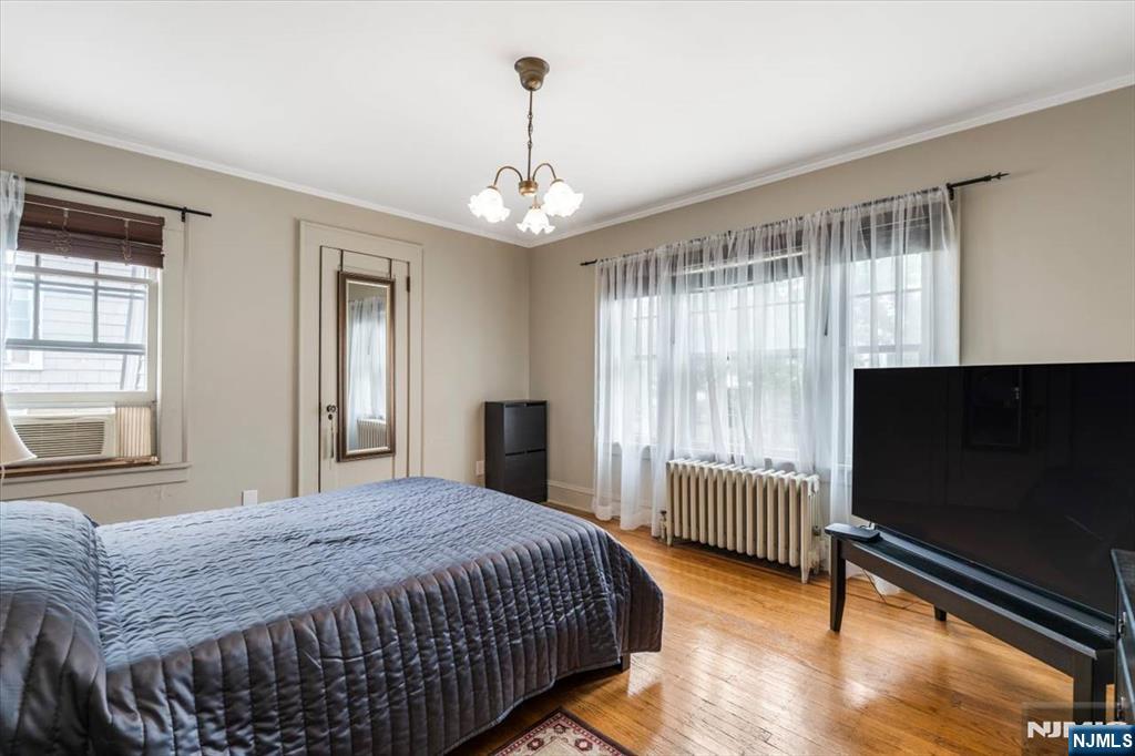 217 Mountain Way Rutherford, NJ 07070 - Photo 21 of 28 a bedroom with a bed tv and a window