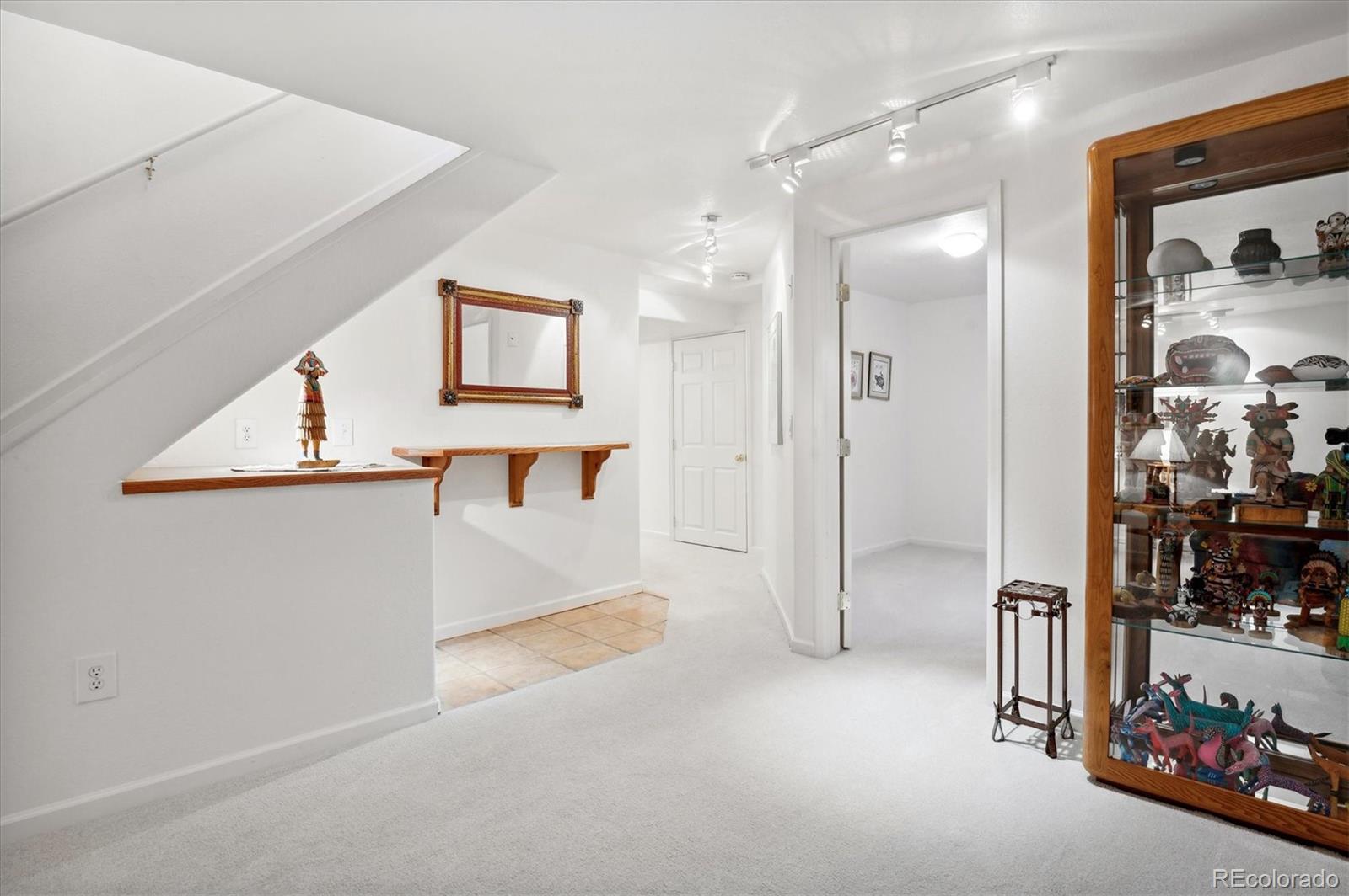 6381 Deframe Way Arvada, CO 80004 - Photo 12 of 22 a view of a hallway with a living room