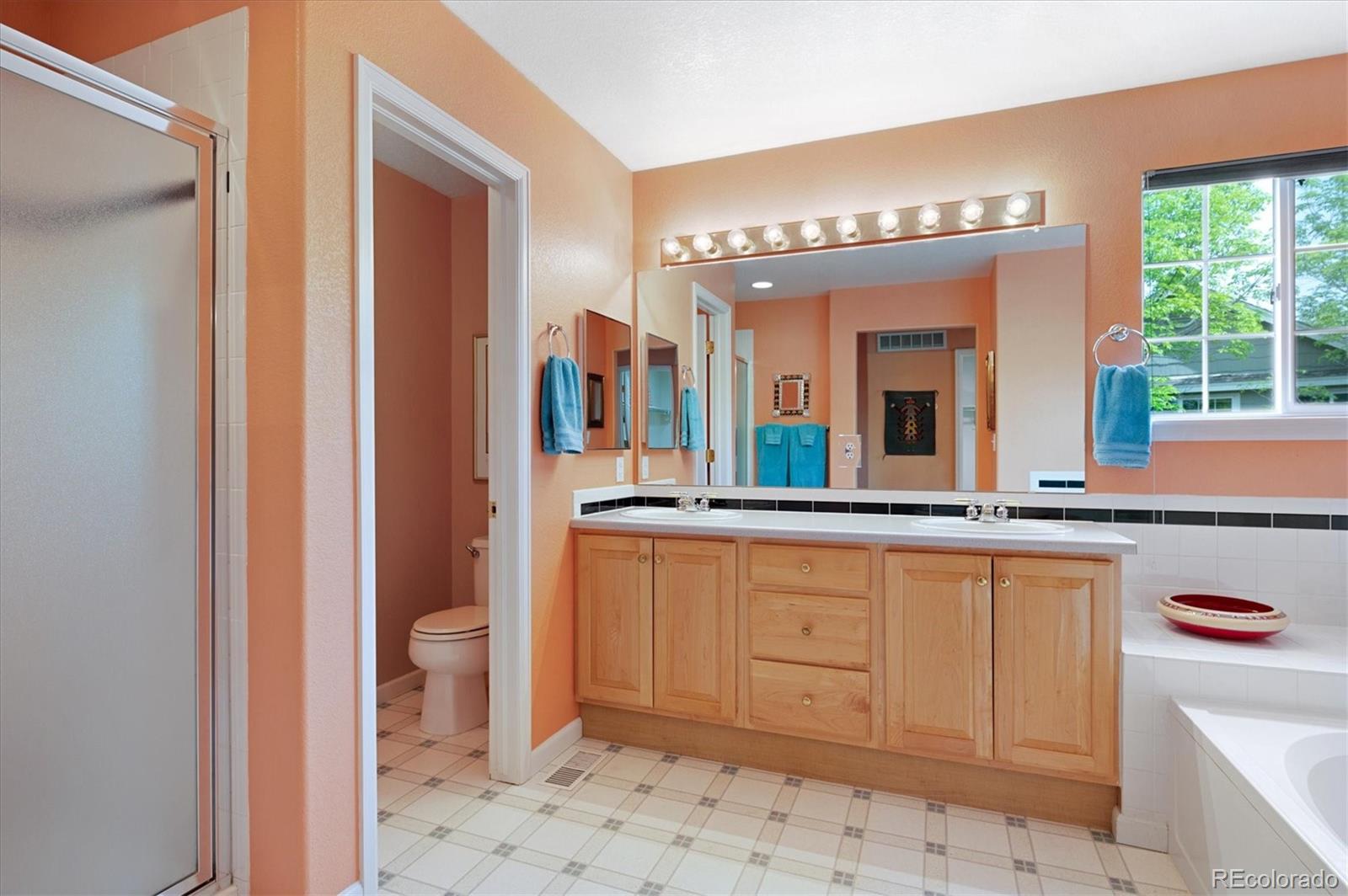 6381 Deframe Way Arvada, CO 80004 - Photo 16 of 22 a spacious bathroom with a mirror and a sink