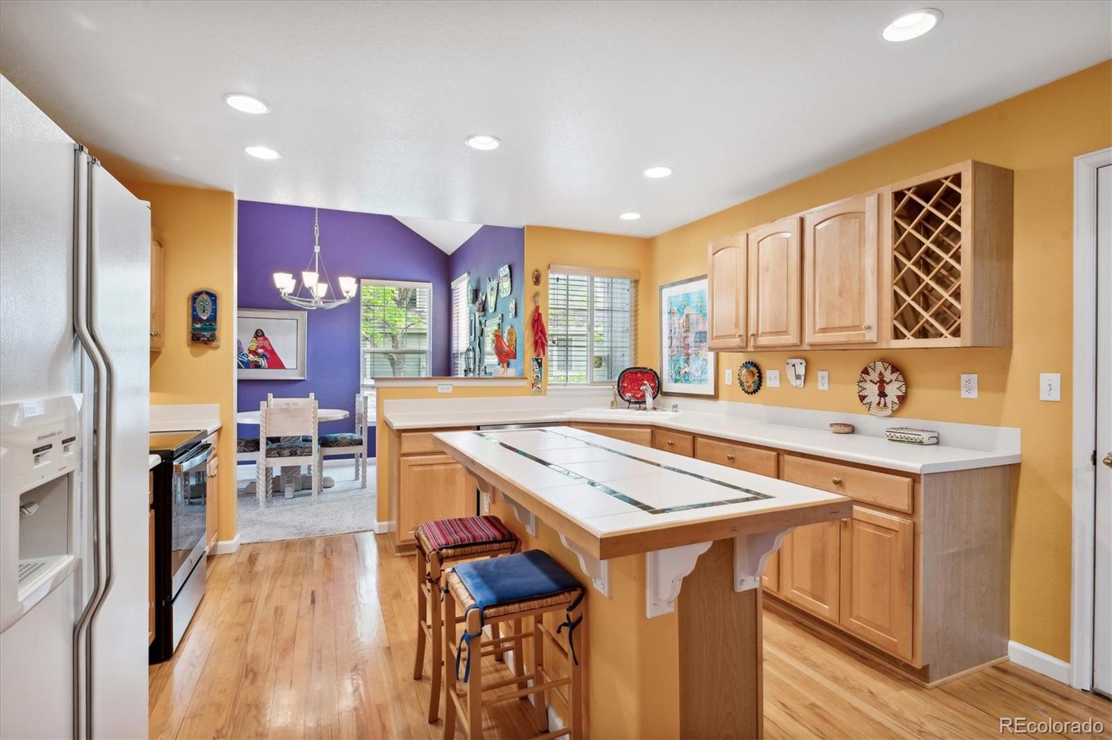 6381 Deframe Way Arvada, CO 80004 - Photo 3 of 22 a kitchen with stainless steel appliances granite countertop a stove and a refrigerator