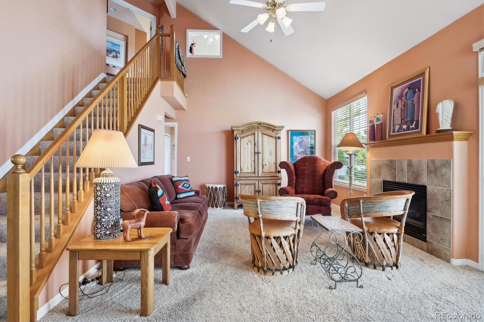 6381 Deframe Way Arvada, CO 80004 - Photo 6 of 22 a living room with furniture a fireplace and a chandelier