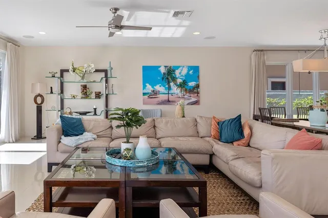 a view of a dining room with furniture a rug and wooden floor