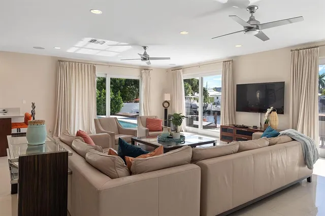 a kitchen with stainless steel appliances a dining table chairs and a refrigerator