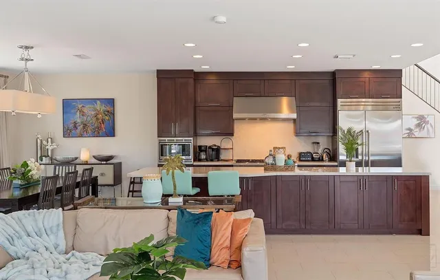 a kitchen with stainless steel appliances granite countertop a stove and a refrigerator