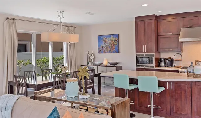 a view of kitchen with cabinets table and chairs