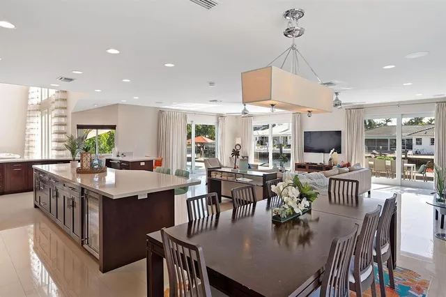 a living room with furniture kitchen view and a wooden floor