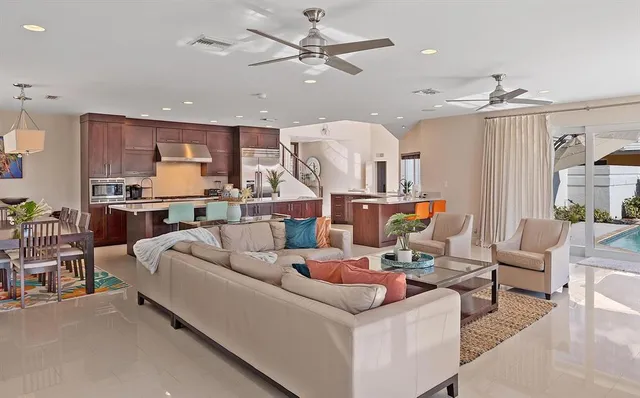 a view of a dining room with furniture a chandelier and wooden floor