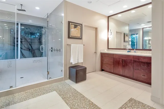 a large bathroom with a granite countertop sink mirror and shower