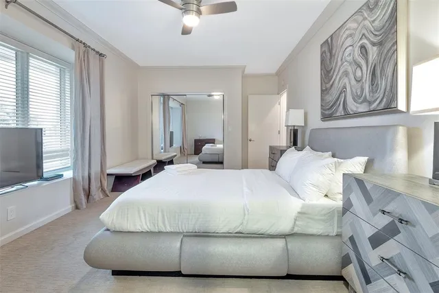 a large bed sitting in a bedroom next to a lamp